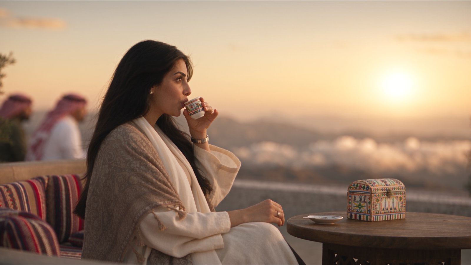 Skywell film still — the same terrace at sunset, coffee at the mountain edge